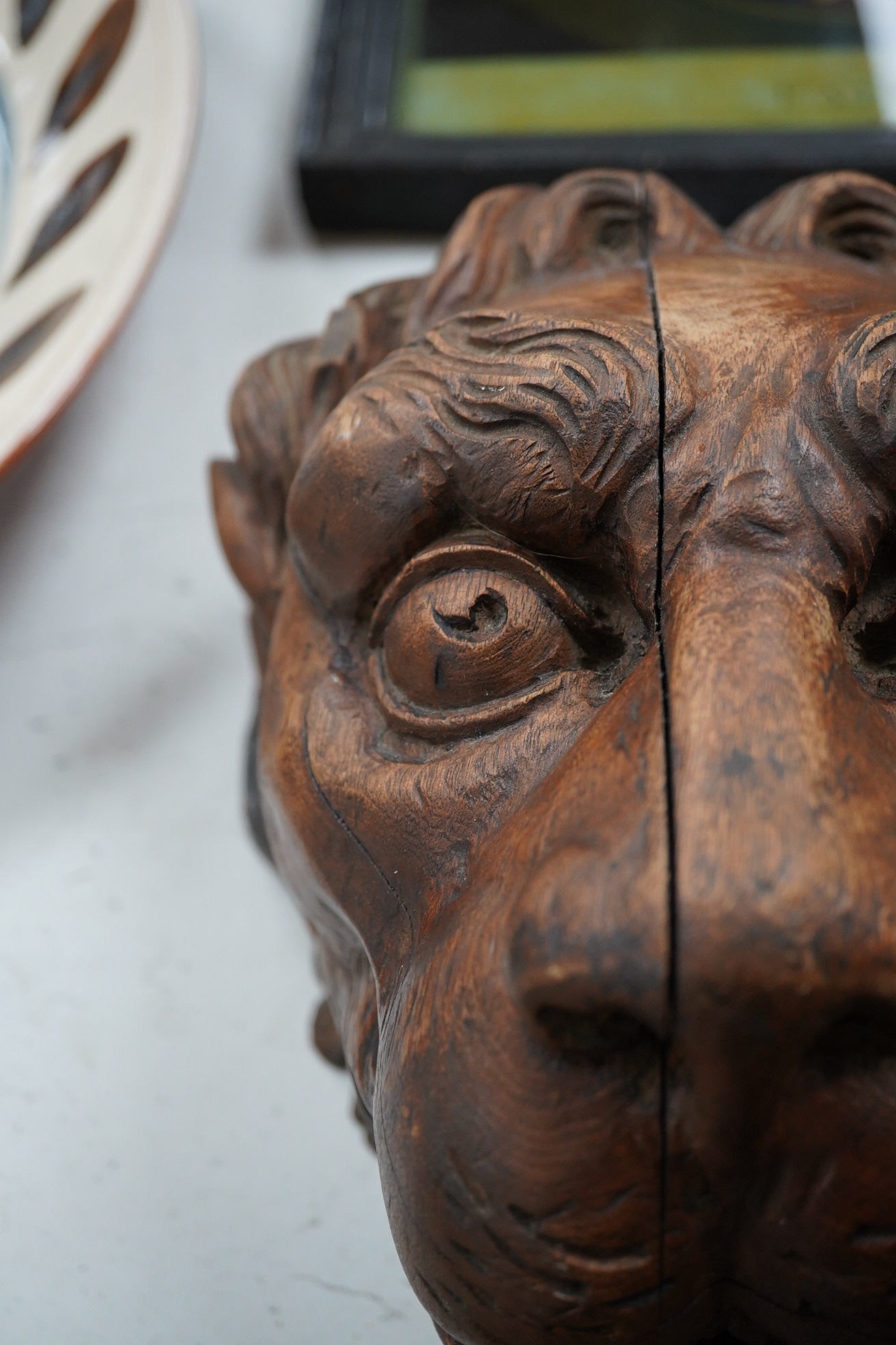 An 19th century carved 'Lion's head' corbel, 21cm high. Condition - poor